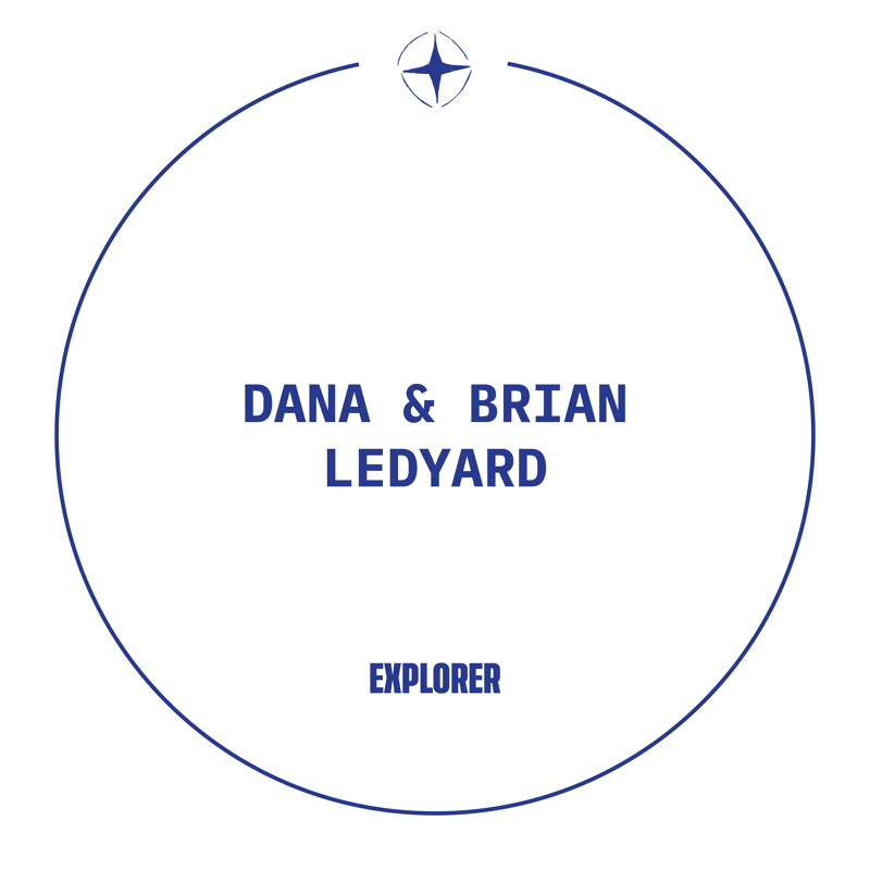 This image features a circular design with the names "DANA & BRIAN LEDYARD" prominently displayed in the center. Below their names, the word "EXPLORER" is written. A stylized compass rose is visible at the top of the circle, suggesting themes of adventure and discovery. The overall aesthetic is clean and modern, with a dark blue color scheme.