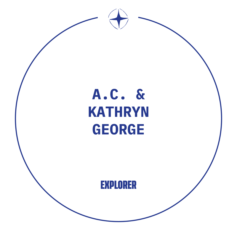 This image features a circular design with the names "A.C. & KATHRYN GEORGE" prominently displayed in the center. Below their names, the word "EXPLORER" is written. A stylized compass rose graphic is positioned at the top, enclosed within the circle's border. The overall aesthetic is clean and modern, utilizing a dark blue color scheme against a white background.