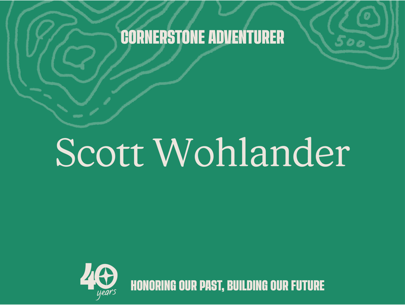 This image features Scott Wohlander, identified as a "Cornerstone Adventurer." The design incorporates a topographic map motif and the text "Honoring Our Past, Building Our Future" alongside a "40 years" celebration. The overall aesthetic suggests an anniversary or recognition event for an individual or organization with a history of exploration or achievement.