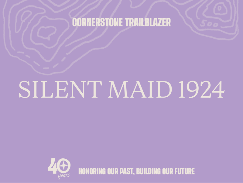 This image is a graphic with a purple background. At the top, it says "CORNERSTONE TRAILBLAZER" with a topographic map design. The central text reads "SILENT MAID 1924". At the bottom, there's a "40 years" logo with the text "HONORING OUR PAST, BUILDING OUR FUTURE". The overall design suggests a commemorative or historical theme.