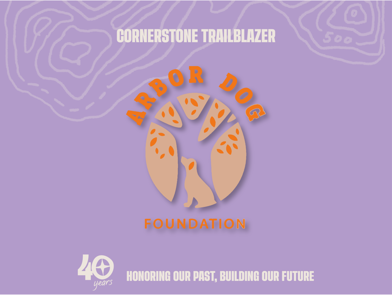 This image features the logo for the Arbor Dog Foundation, a "Cornerstone Trailblazer" celebrating 40 years. The logo is a stylized tree with a dog silhouette at its base, set against a purple background with topographic lines. The foundation's mission is "Honoring Our Past, Building Our Future."