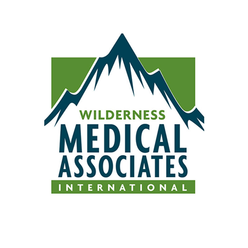 This is a logo for Wilderness Medical Associates International. It features a stylized mountain range in dark blue and green, set against a green square background. The text "WILDERNESS MEDICAL ASSOCIATES INTERNATIONAL" is prominently displayed in a dark blue sans-serif font below the mountain graphic. The overall design evokes a sense of adventure and expertise in outdoor medicine.